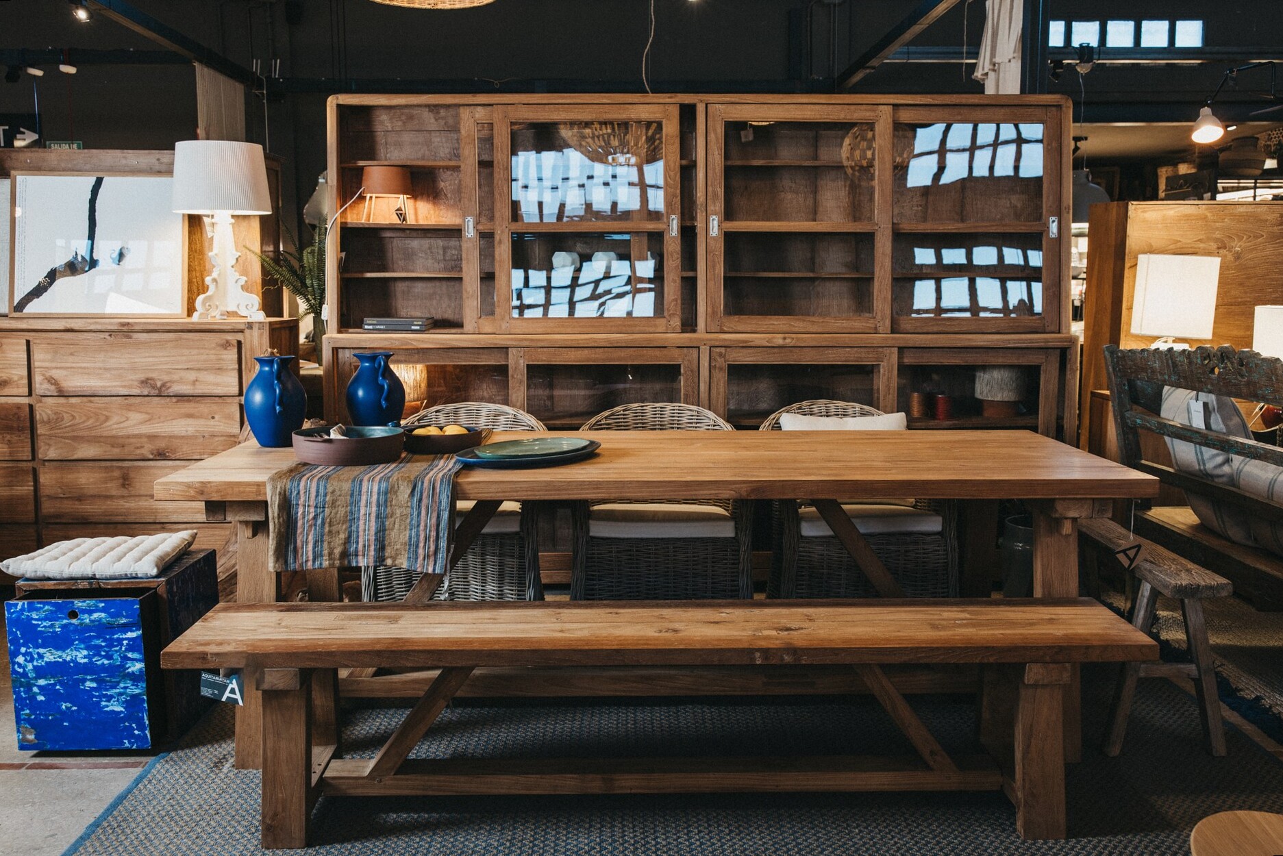 Table à manger en bois massif et vitrines dans la boutique de Maó
